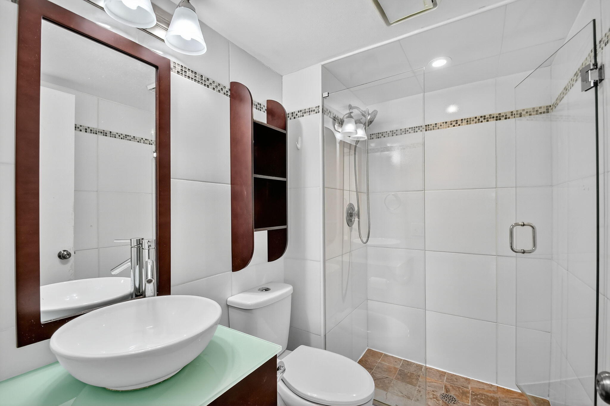 5040 Rose Hill Drive, Unit 206 Boynton Beach, FL 33437 - Photo 27 of 54 a bathroom with a toilet a sink and shower