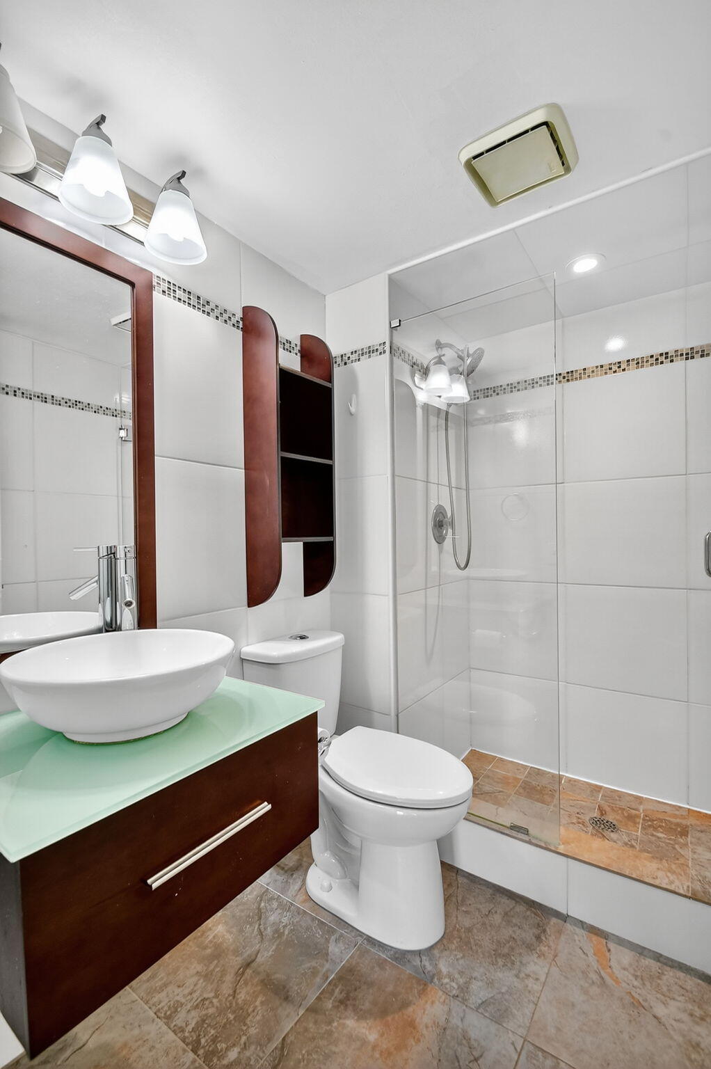 5040 Rose Hill Drive, Unit 206 Boynton Beach, FL 33437 - Photo 28 of 54 a bathroom with a sink a toilet a mirror and shower