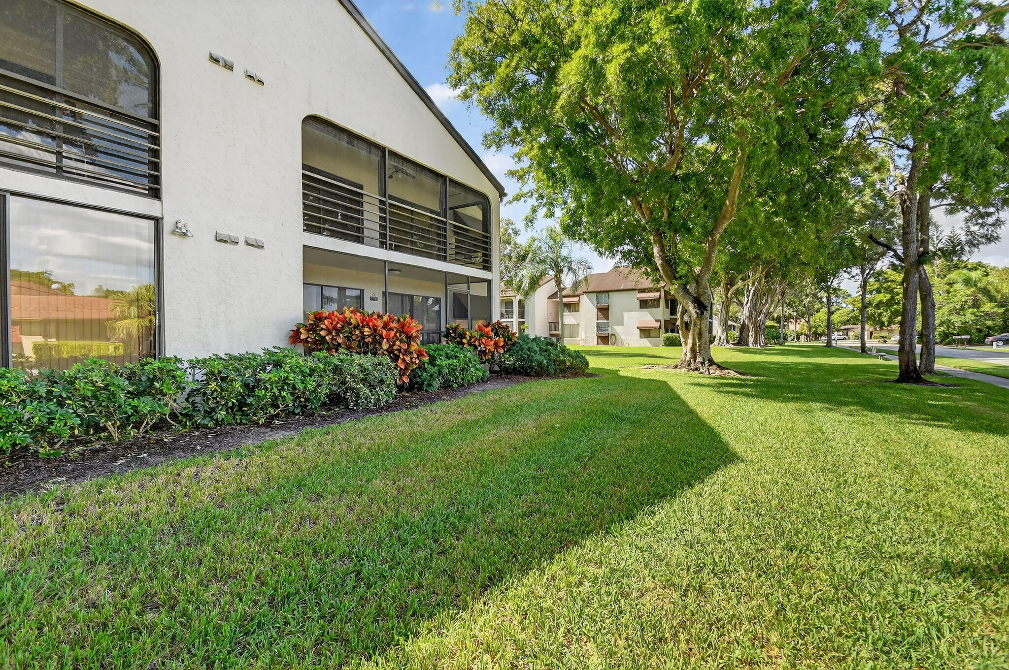 5040 Rose Hill Drive, Unit 206 Boynton Beach, FL 33437 - Photo 34 of 54 a front view of a house with garden