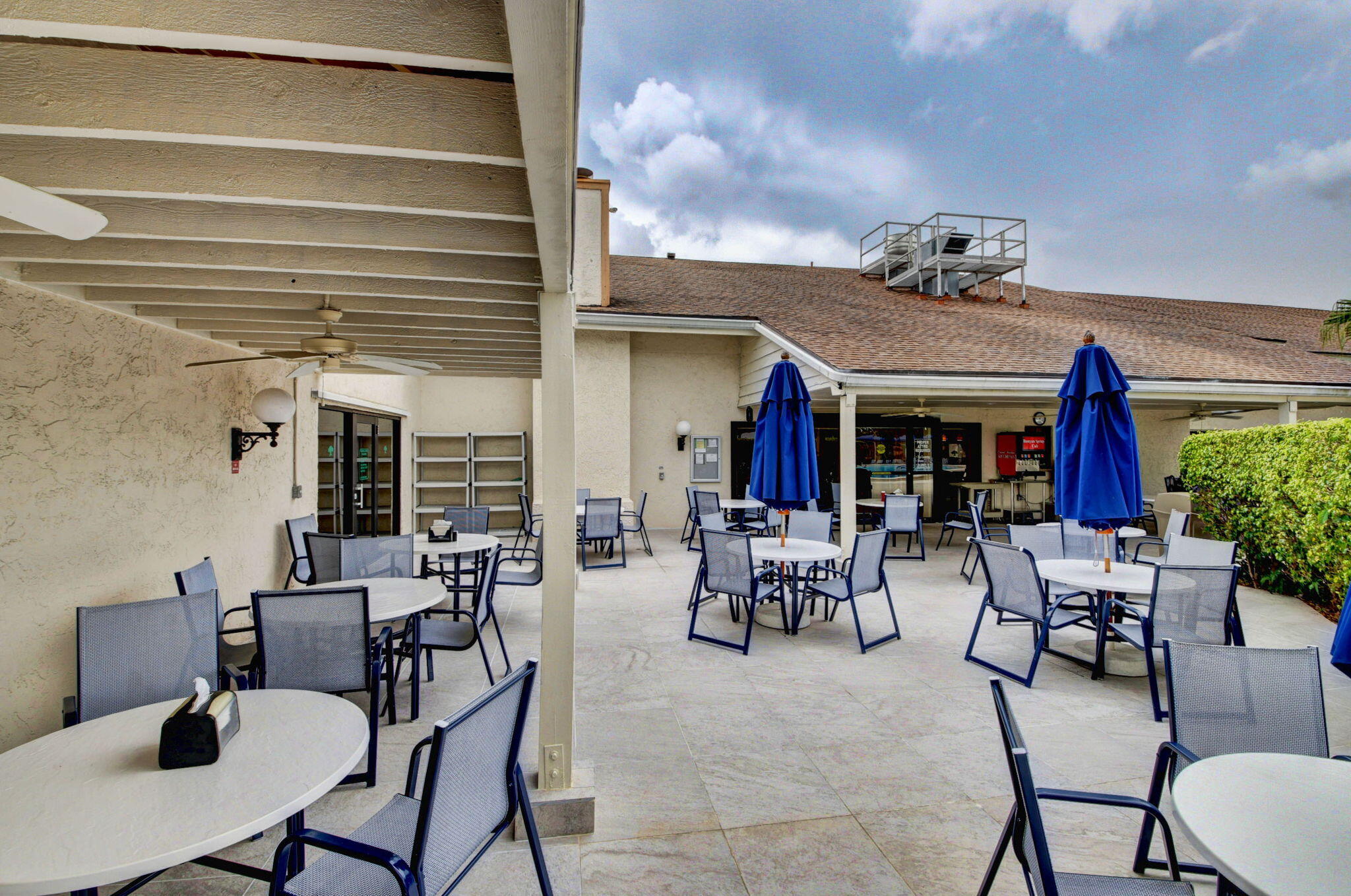 5040 Rose Hill Drive, Unit 206 Boynton Beach, FL 33437 - Photo 49 of 54 a view of a dinning tables and chairs in the patio