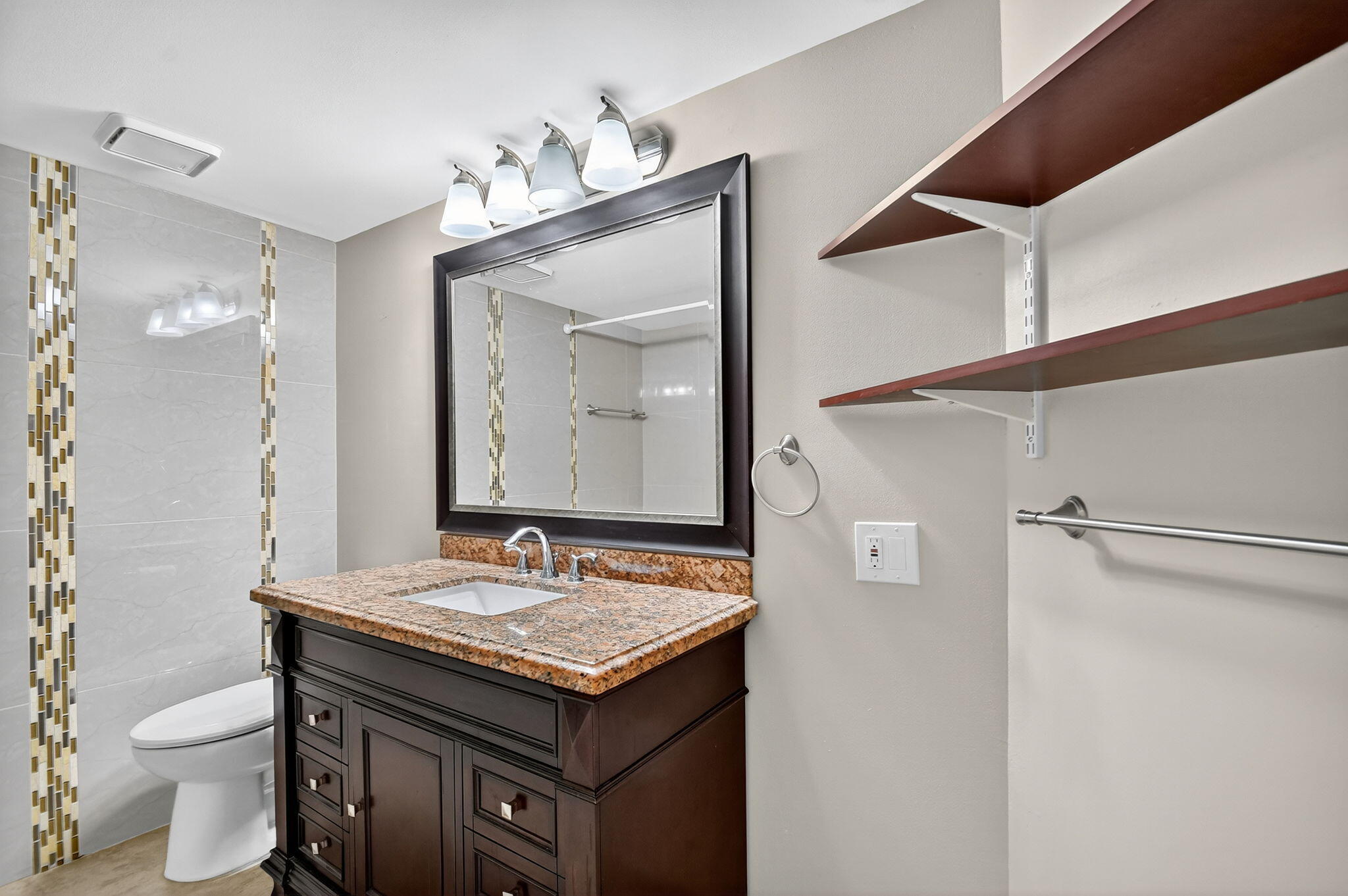 5040 Rose Hill Drive, Unit 206 Boynton Beach, FL 33437 - Photo 6 of 54 a bathroom with a granite countertop sink toilet and mirror
