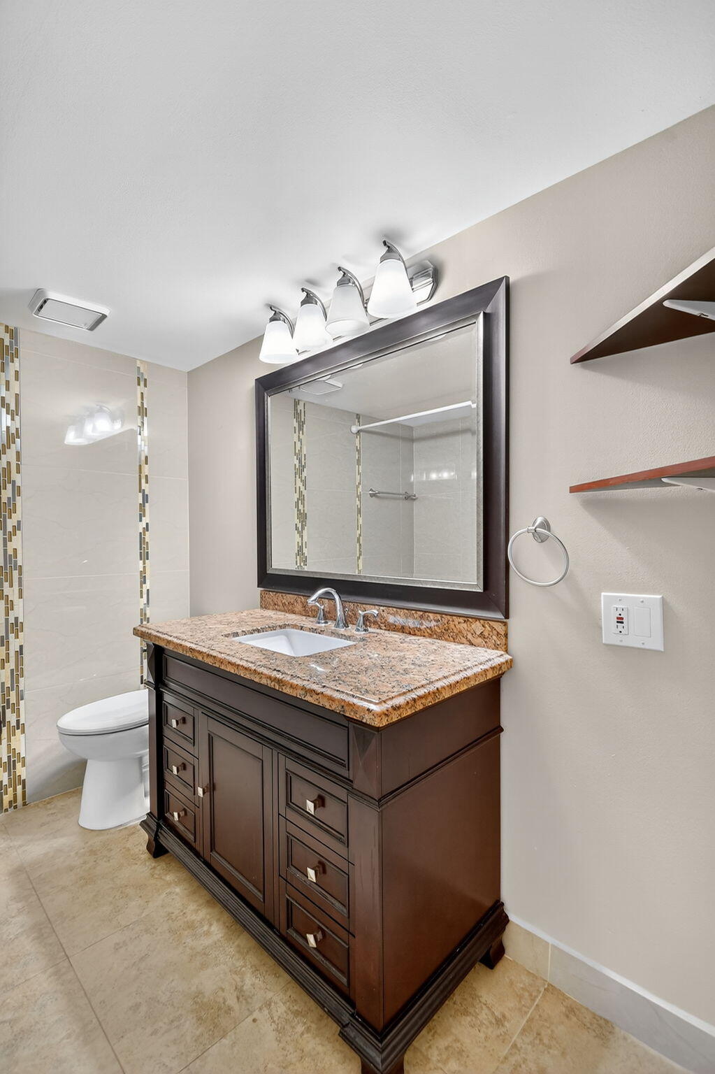 5040 Rose Hill Drive, Unit 206 Boynton Beach, FL 33437 - Photo 8 of 54 a bathroom with a granite countertop sink a toilet and a mirror