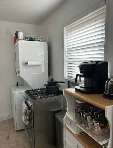 a kitchen with stainless steel appliances a stove a sink and a microwave