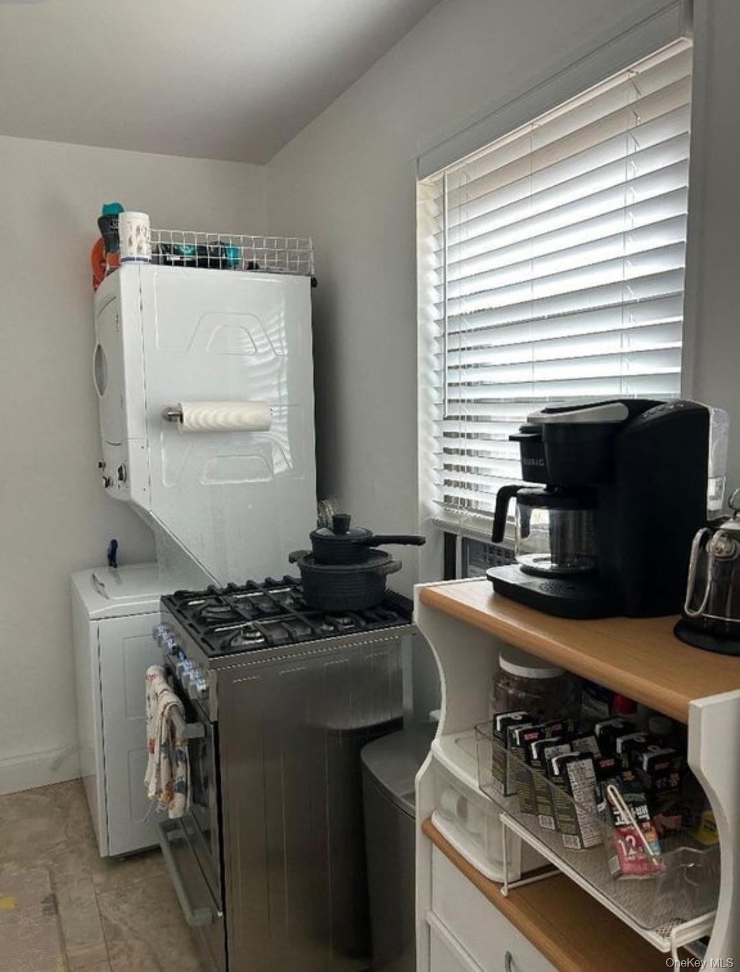 199-05 21st Avenue, Unit 1 Queens, NY 11357 - Photo 11 of 13 a kitchen with stainless steel appliances a stove a sink and a microwave