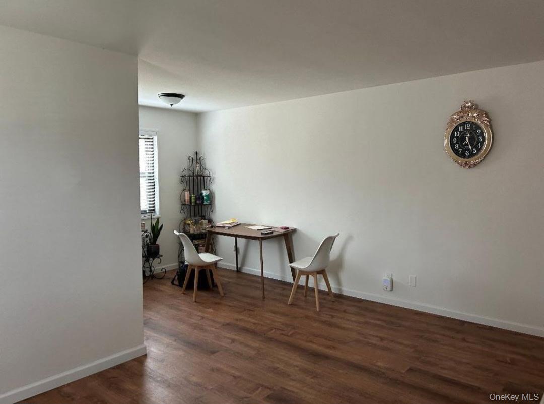 199-05 21st Avenue, Unit 1 Queens, NY 11357 - Photo 7 of 13 a view of a workspace with furniture and wooden floor