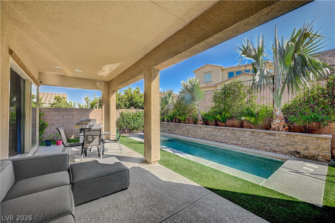 3943 Reyes Avenue Las Vegas, NV 89141 - Photo 54 of 95 An inviting covered patio offers a refreshing pool and an ideal space for outdoor enjoyment.