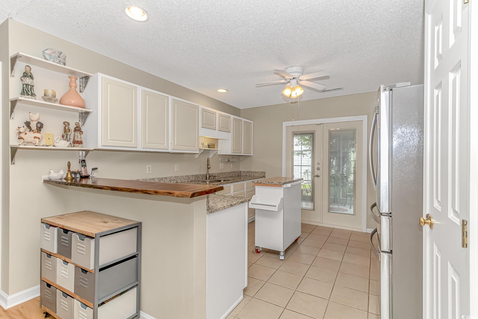 441 Plymouth Loop Longs, SC 29568 - Photo 11 of 33 Kitchen with light tile patterned floors, open she