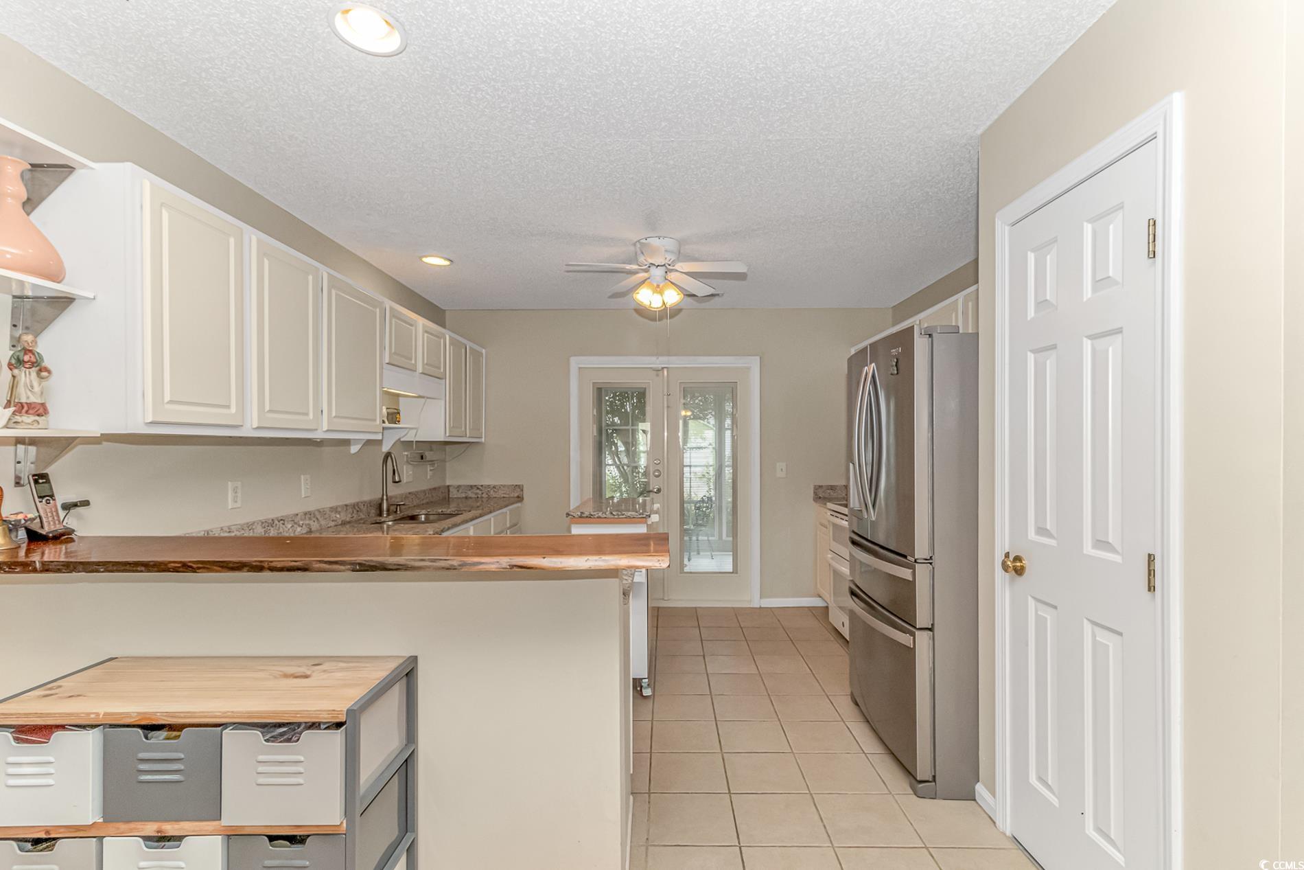 441 Plymouth Loop Longs, SC 29568 - Photo 12 of 33 Kitchen with open shelves, light tile patterned fl