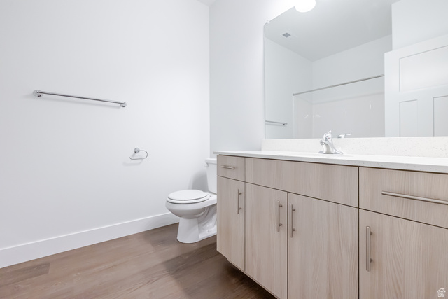 4704 Olive Avenue, Unit V202 Mapleton, UT 84664 - Photo 9 of 17 Wood-finish flooring, white walls, and a light wood-finish vanity with chrome hardware