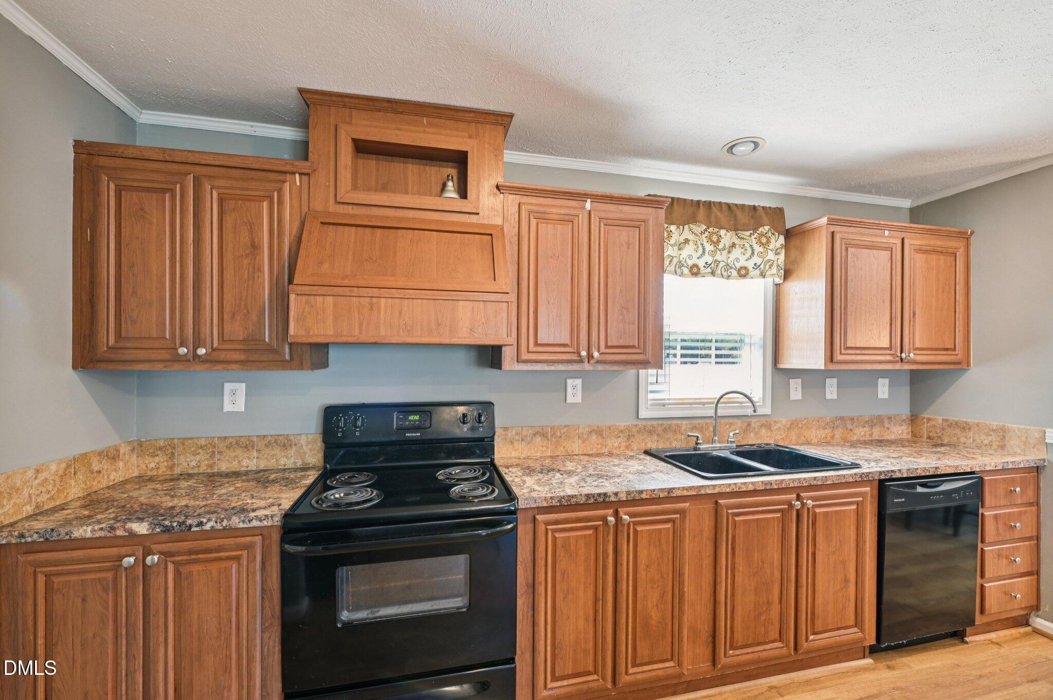 2186 Piney Grove Church Road Kenly, NC 27542 - Photo 11 of 30 a kitchen with granite countertop a stove sink and cabinets