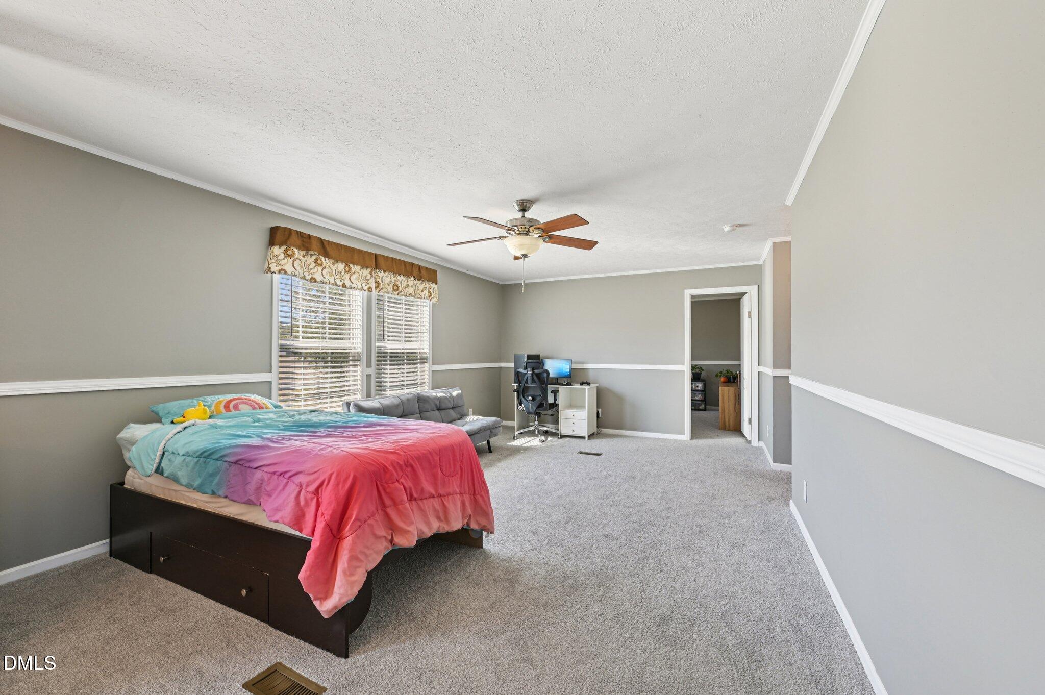 2186 Piney Grove Church Road Kenly, NC 27542 - Photo 13 of 30 a bed room with a bed and a chair