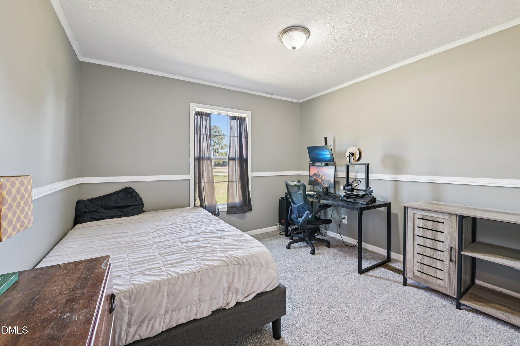 2186 Piney Grove Church Road Kenly, NC 27542 - Photo 17 of 30 a bedroom with a bed and a table in it