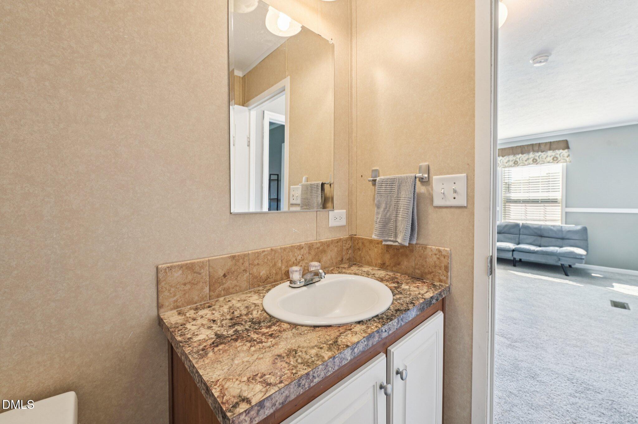 2186 Piney Grove Church Road Kenly, NC 27542 - Photo 22 of 30 a bathroom with a sink and a mirror