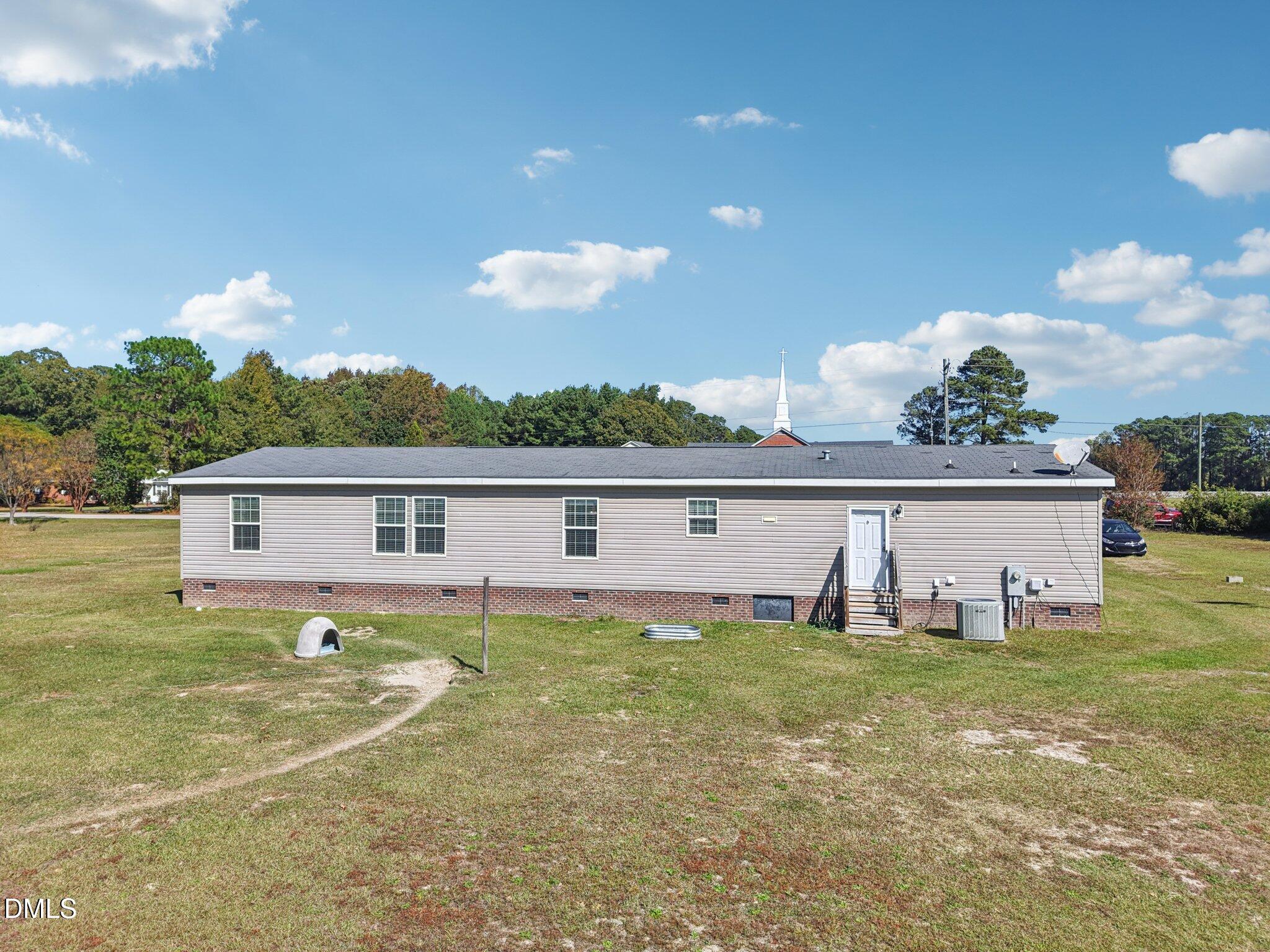 2186 Piney Grove Church Road Kenly, NC 27542 - Photo 27 of 30 a view of a house with a yard