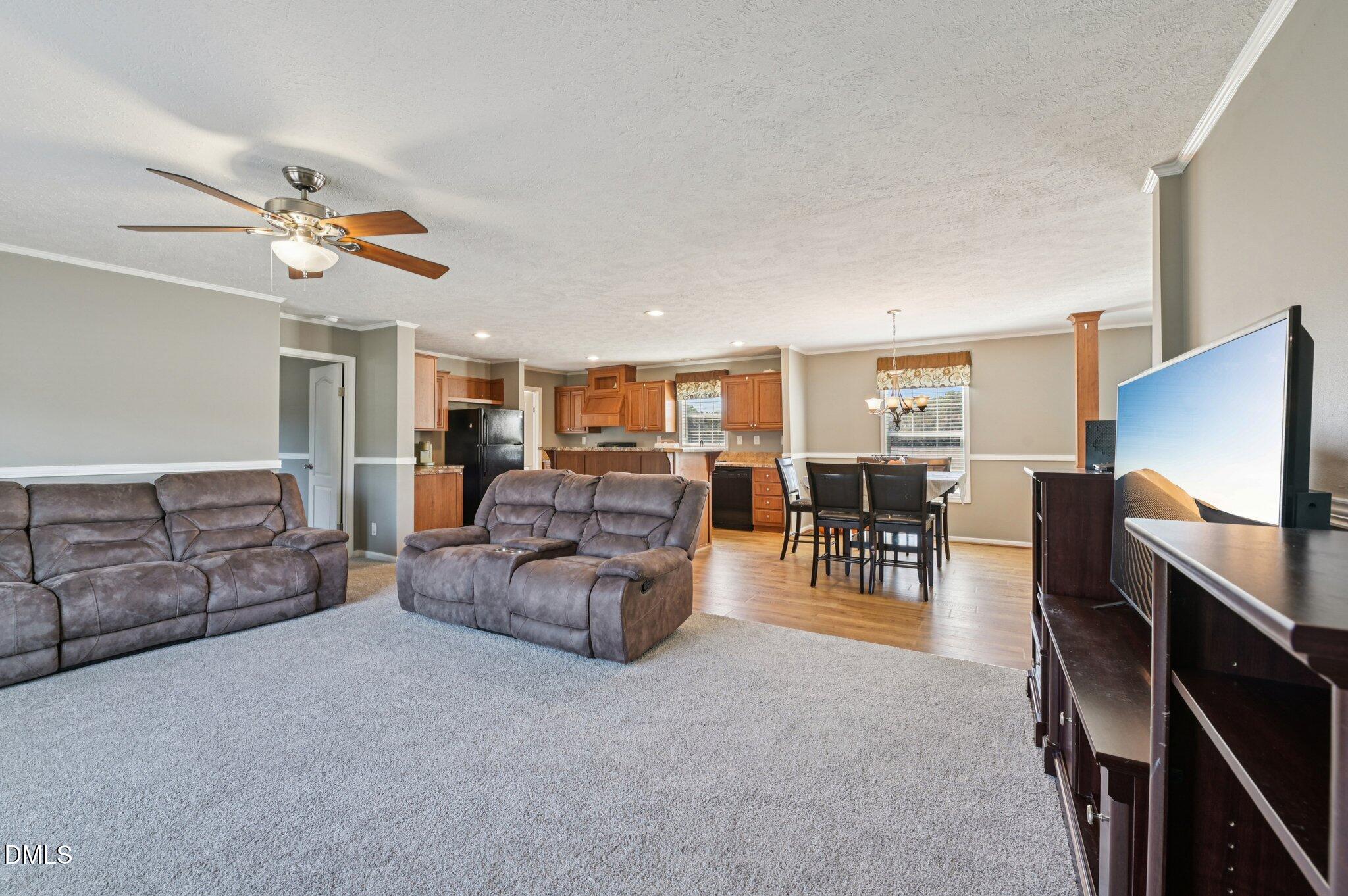 2186 Piney Grove Church Road Kenly, NC 27542 - Photo 4 of 30 a living room with furniture a flat screen tv and gym equipment