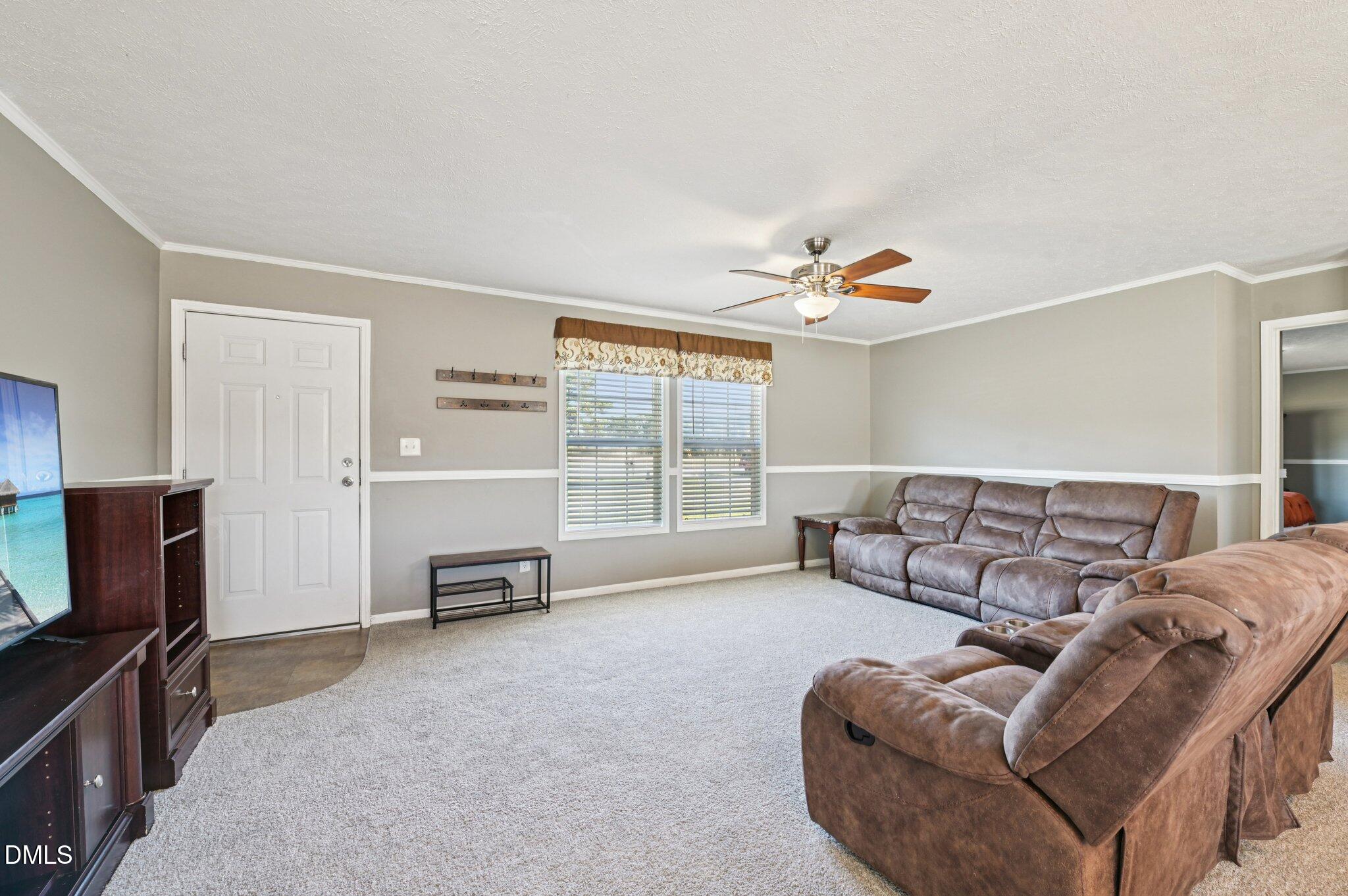 2186 Piney Grove Church Road Kenly, NC 27542 - Photo 5 of 30 a living room with furniture and a flat screen tv