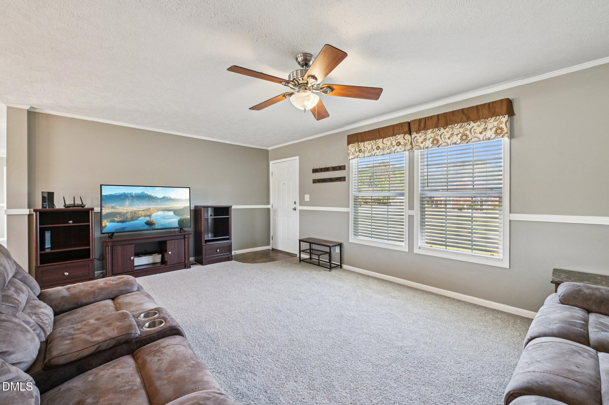 2186 Piney Grove Church Road Kenly, NC 27542 - Photo 6 of 30 a living room with furniture ceiling fan and a flat screen tv
