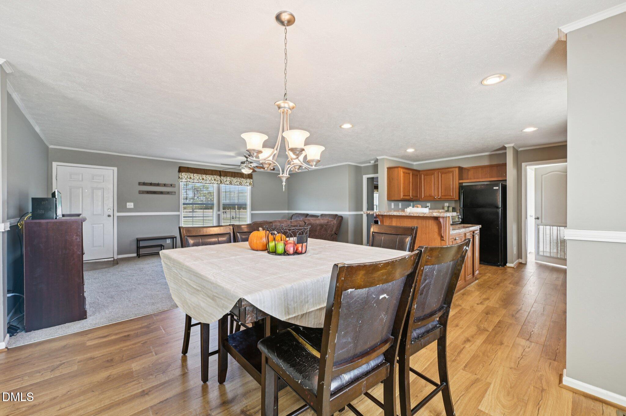 2186 Piney Grove Church Road Kenly, NC 27542 - Photo 7 of 30 a view of a dining room and livingroom with furniture wooden floor a chandelier