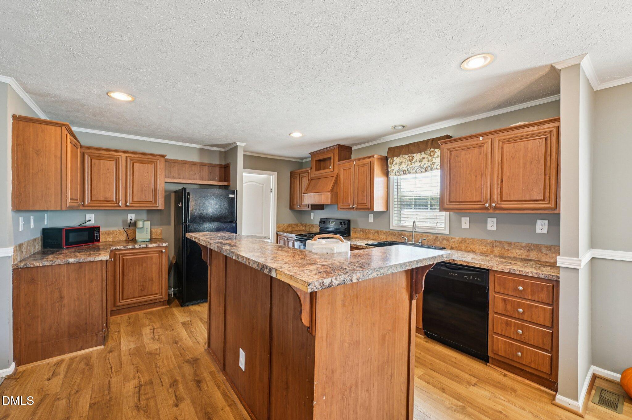 2186 Piney Grove Church Road Kenly, NC 27542 - Photo 8 of 30 a kitchen with a sink stove top oven and refrigerator