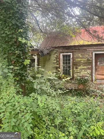 a backyard of a house with large trees