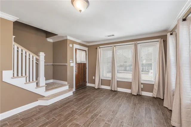 an empty room with wooden floor and door