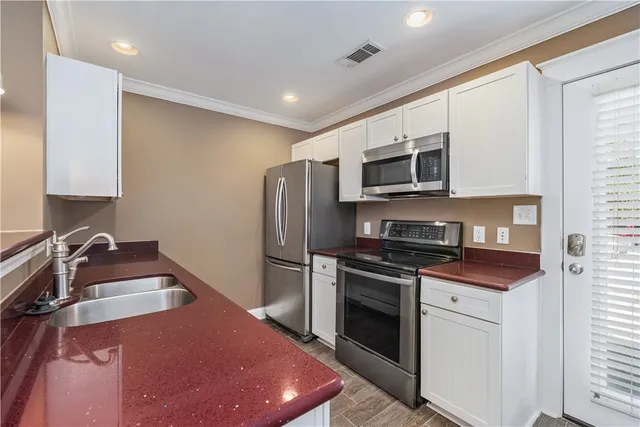 a kitchen with a sink stove and refrigerator