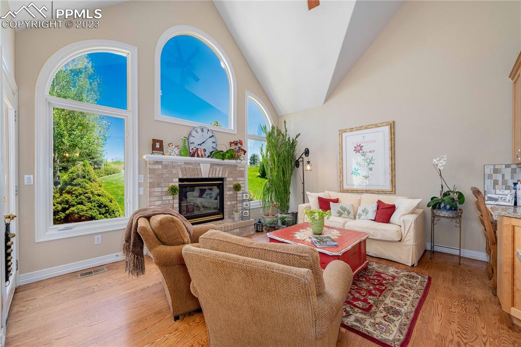 8760 Ridgepointe Drive Castle Pines, CO 80108 - Photo 18 of 50 a living room with furniture a fireplace and a window