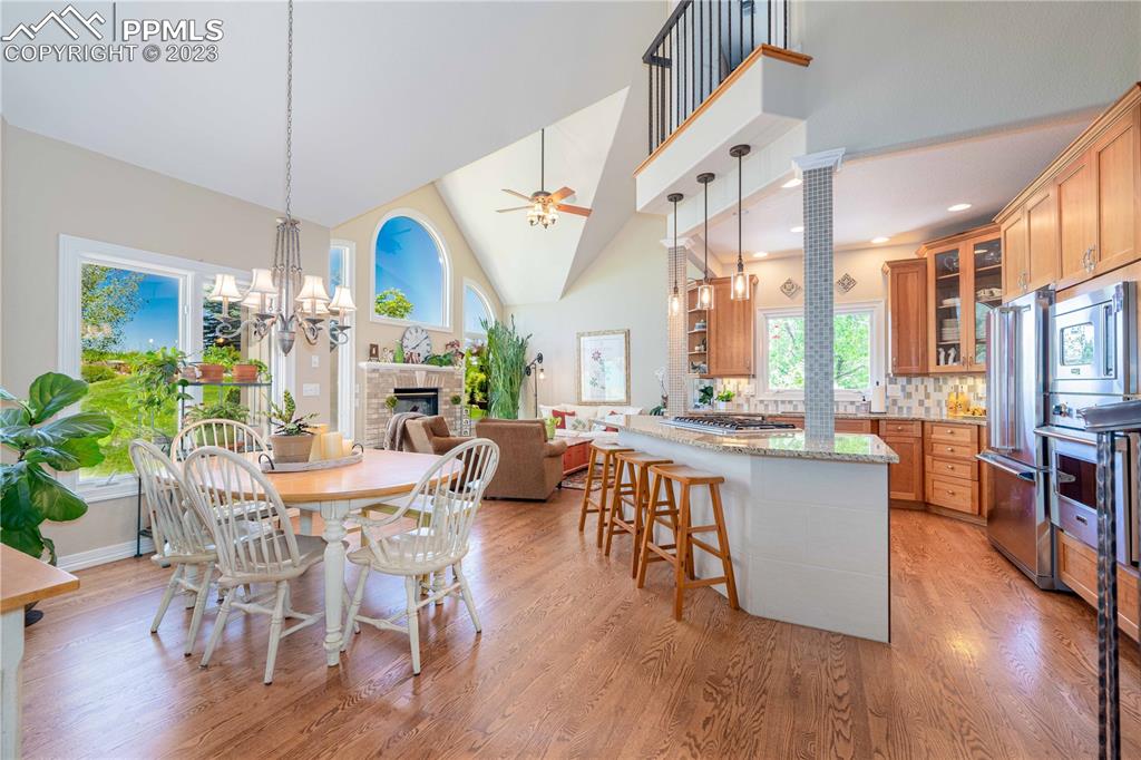 8760 Ridgepointe Drive Castle Pines, CO 80108 - Photo 19 of 50 a view of a dining room with furniture window and wooden floor