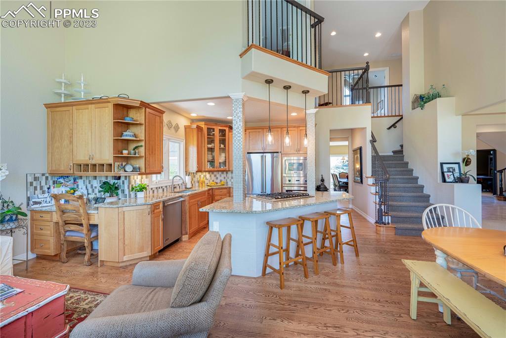 8760 Ridgepointe Drive Castle Pines, CO 80108 - Photo 20 of 50 a living room with furniture a flat screen tv and a table