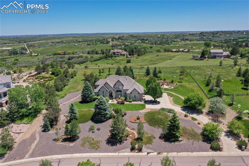 8760 Ridgepointe Drive Castle Pines, CO 80108 - Photo 2 of 50 an aerial view of a houses with outdoor space
