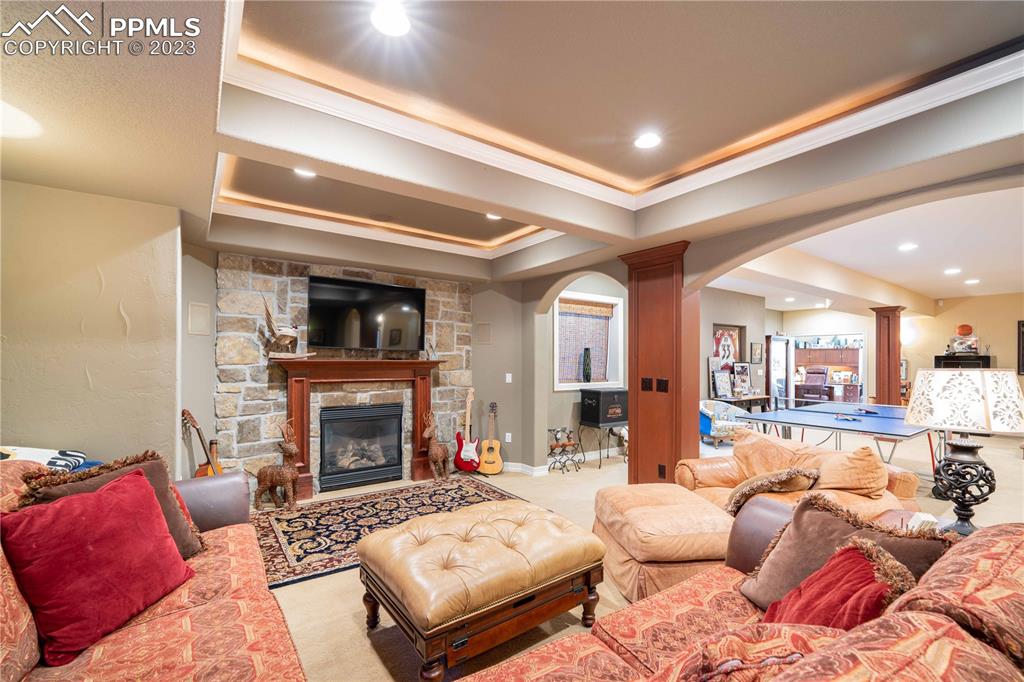 8760 Ridgepointe Drive Castle Pines, CO 80108 - Photo 27 of 50 a living room with furniture and a fireplace