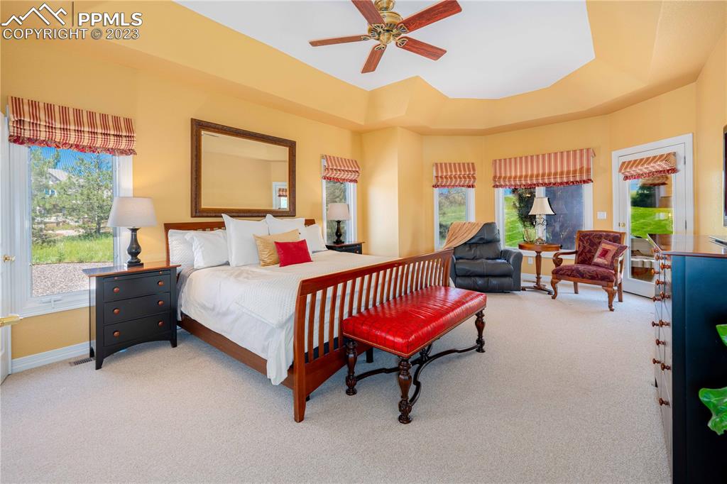 8760 Ridgepointe Drive Castle Pines, CO 80108 - Photo 30 of 50 a bedroom with a bed and a chandelier