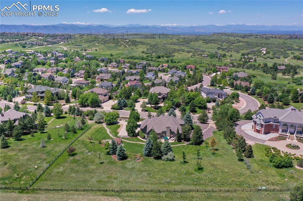 8760 Ridgepointe Drive Castle Pines, CO 80108 - Photo 3 of 50 an aerial view of residential houses with outdoor space and trees