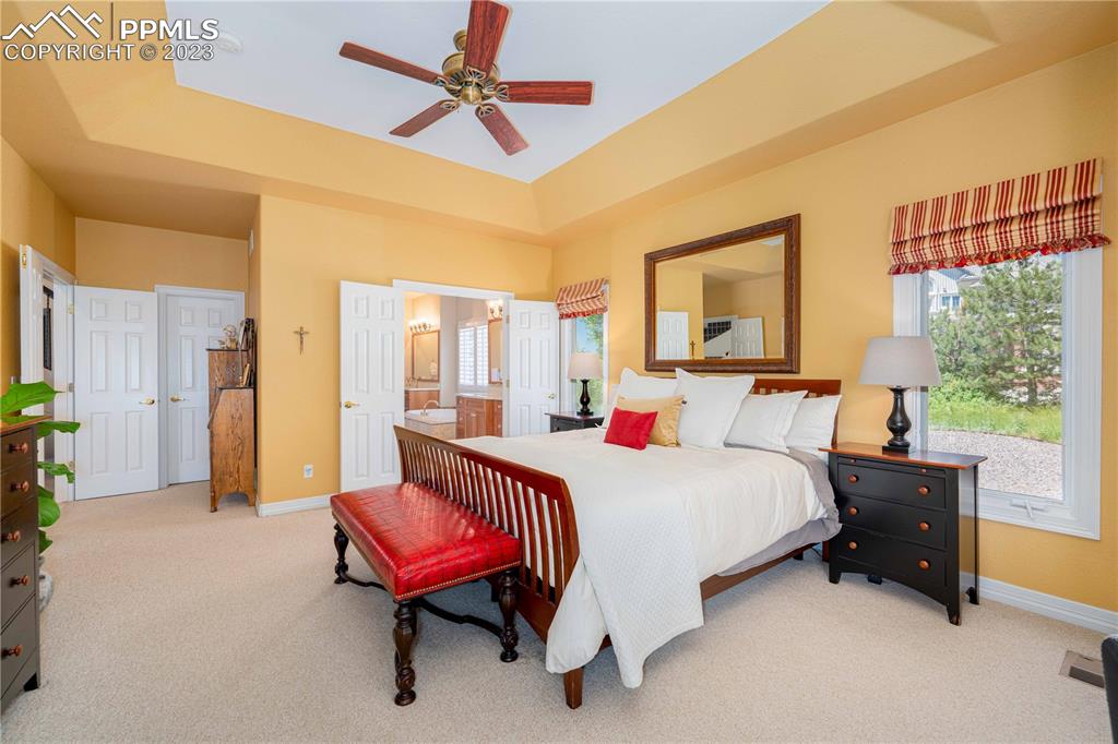 8760 Ridgepointe Drive Castle Pines, CO 80108 - Photo 31 of 50 a bedroom with a bed and a chandelier