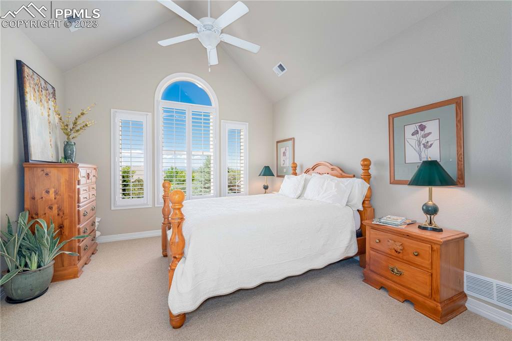 8760 Ridgepointe Drive Castle Pines, CO 80108 - Photo 34 of 50 a bedroom with furniture and a chandelier