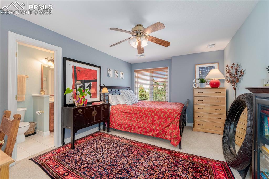 8760 Ridgepointe Drive Castle Pines, CO 80108 - Photo 37 of 50 a bedroom with furniture and a flat screen tv