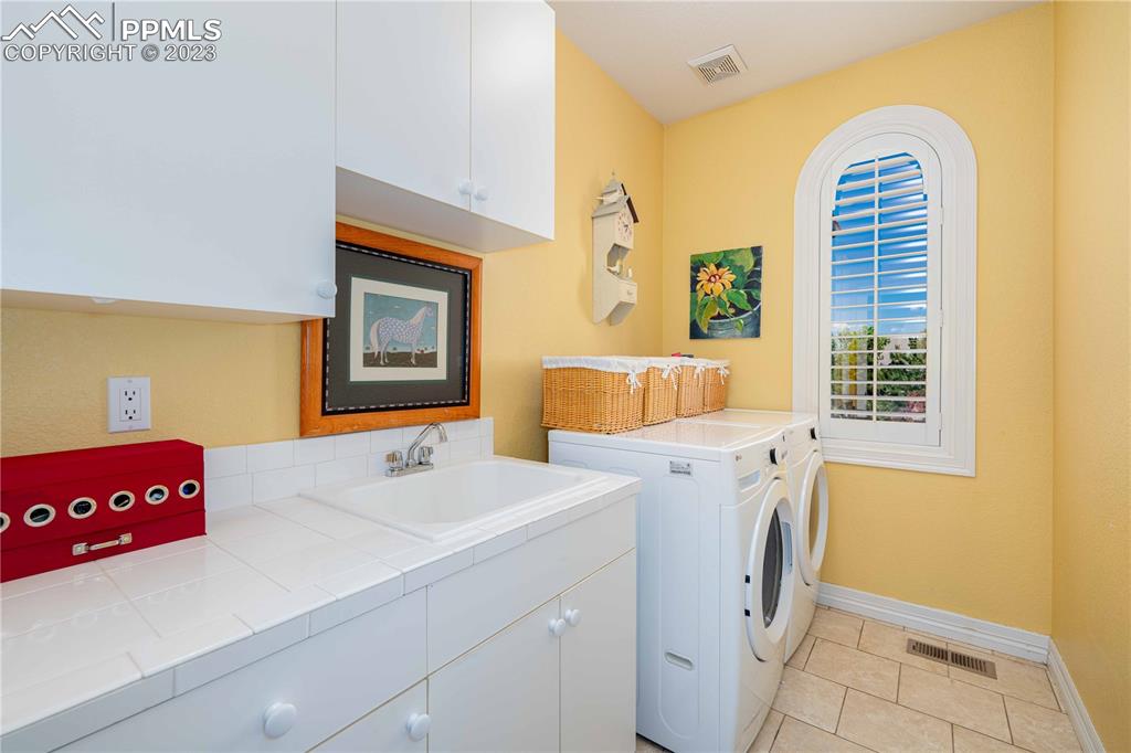 8760 Ridgepointe Drive Castle Pines, CO 80108 - Photo 42 of 50 a utility room with dryer and washer