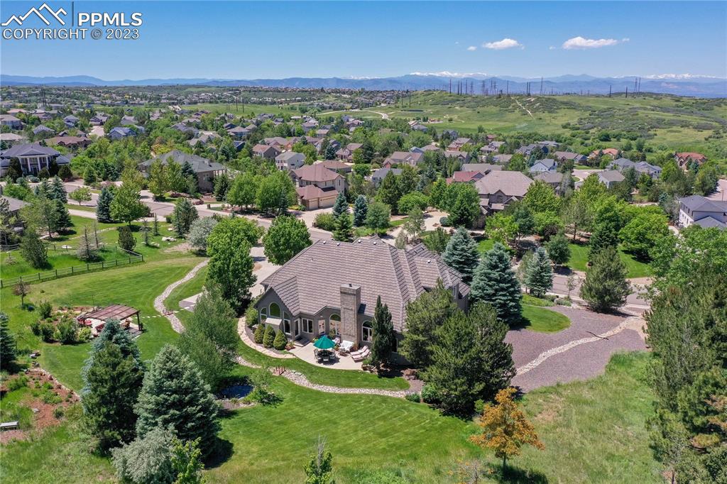 8760 Ridgepointe Drive Castle Pines, CO 80108 - Photo 45 of 50 an aerial view of residential houses with outdoor space and garden