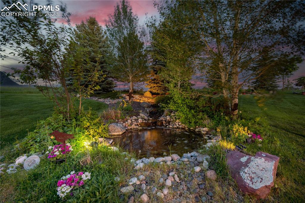 8760 Ridgepointe Drive Castle Pines, CO 80108 - Photo 47 of 50 a view of a garden with flowers and trees
