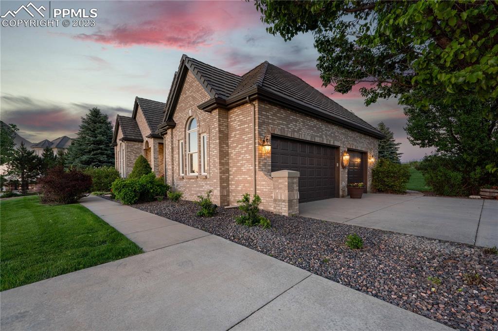8760 Ridgepointe Drive Castle Pines, CO 80108 - Photo 48 of 50 a front view of a house with garden