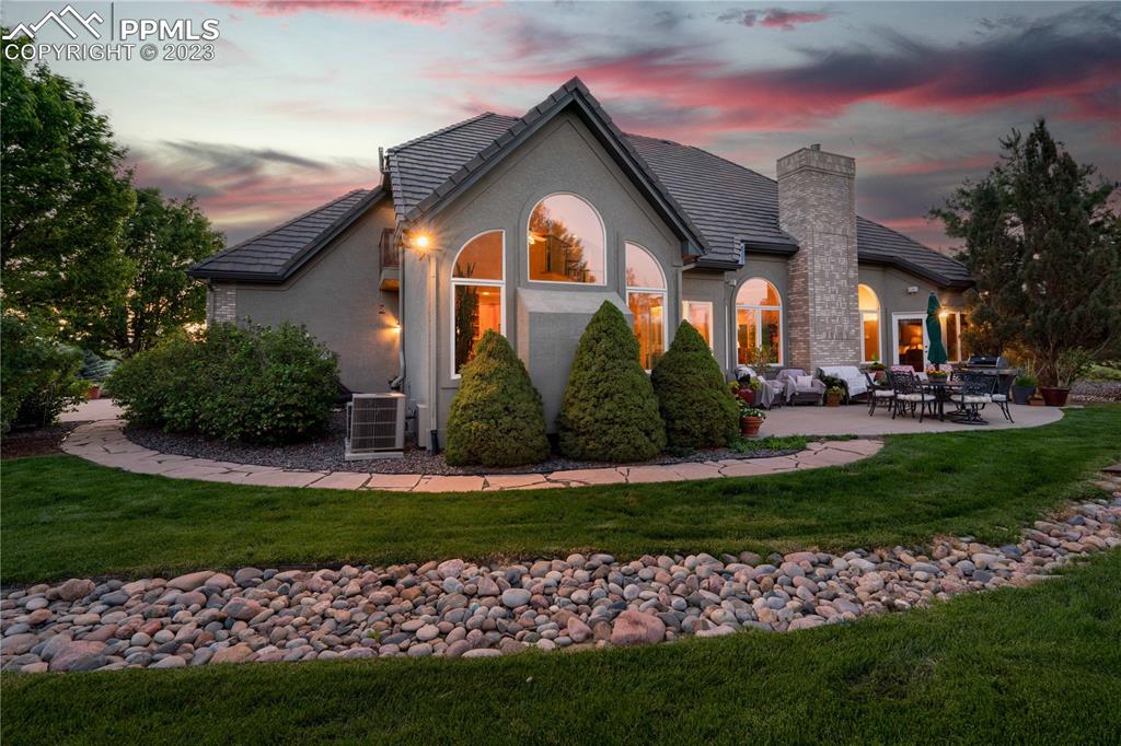 8760 Ridgepointe Drive Castle Pines, CO 80108 - Photo 49 of 50 a front view of a house with a garden