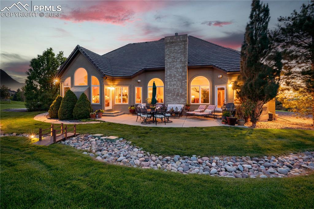 8760 Ridgepointe Drive Castle Pines, CO 80108 - Photo 6 of 50 a front view of a house with a yard