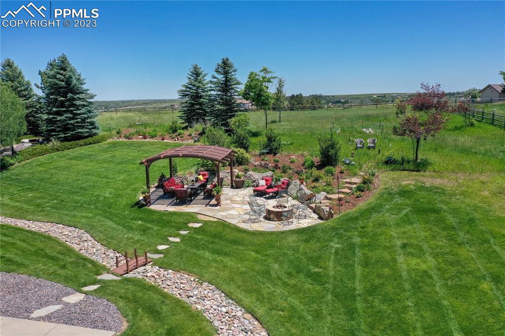 8760 Ridgepointe Drive Castle Pines, CO 80108 - Photo 7 of 50 a view of a backyard with plants and outdoor seating