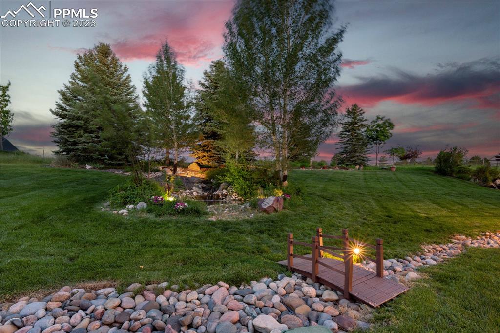 8760 Ridgepointe Drive Castle Pines, CO 80108 - Photo 10 of 50 a backyard of a house with lots of green space