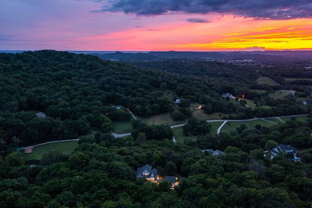 a living room with furniture a fireplace and a large window