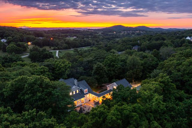 a living room with fireplace furniture and a floor to ceiling window