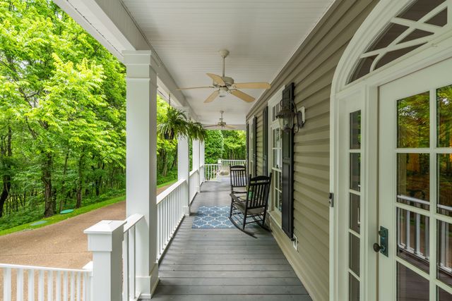 a living room with furniture a fireplace and a chandelier
