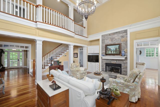 a view of a dining room with furniture a chandelier and wooden floor