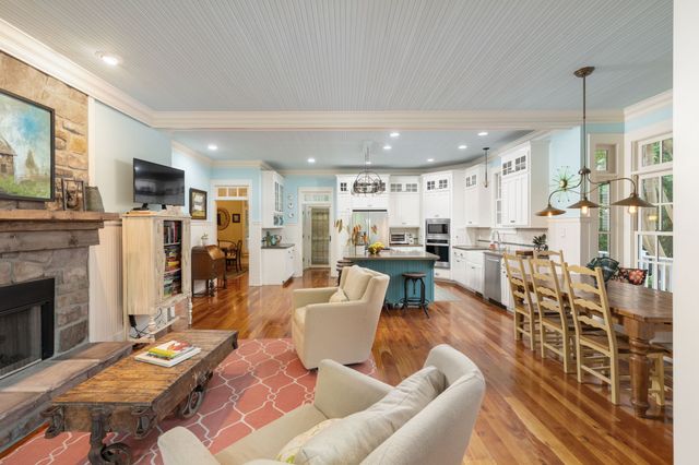 a front view of a house with yard and green space