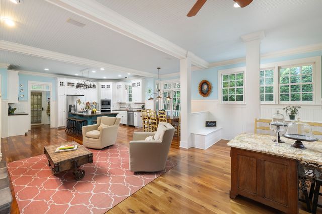 a view of a house with a big yard and large trees